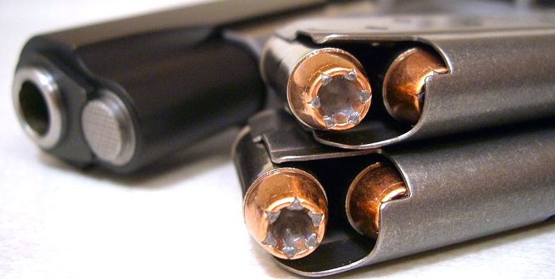 10mm JHP ammo in loaded magazines with a handgun